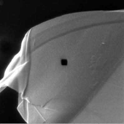 ORION® PLUS image of graphene layers showing ion milling. The small square area in the center is a 100nm box machined completely through the material. The edge acuity of the box demonstrates the excellent achievable resolution which can be achieved for patterning.