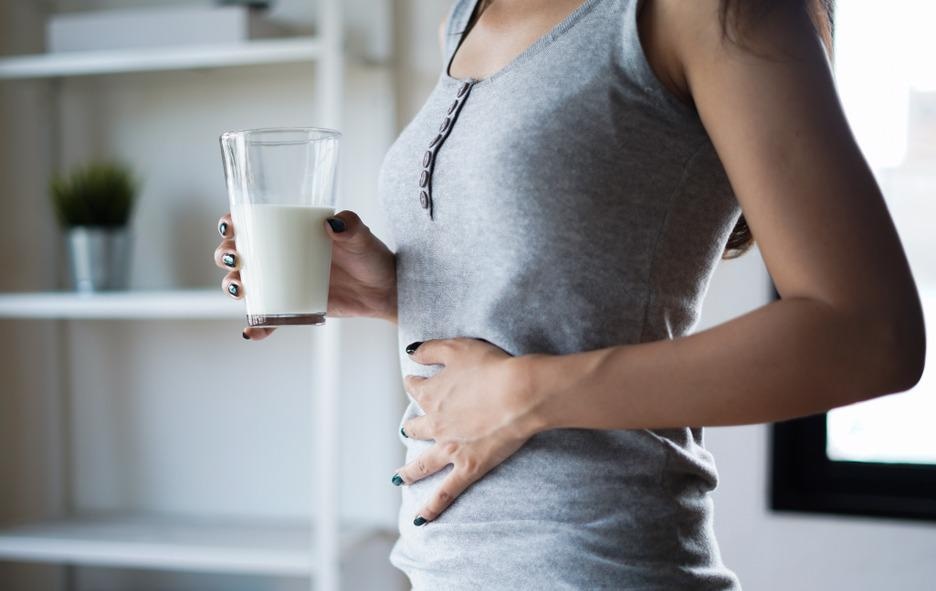 woman holding glass of milk, lactose intolerance