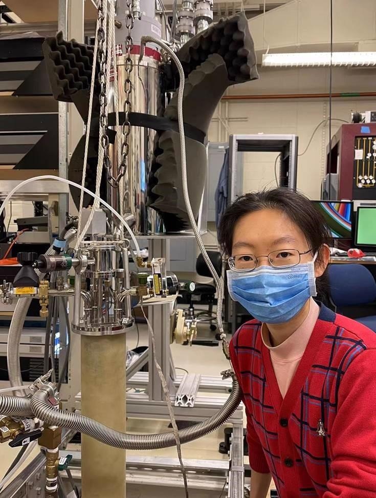 Xirui Wang loading a sample in the lab.