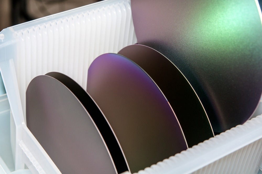 Several silicon wafers in white carrier for the fabrication of integrated circuits.