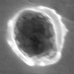 Interstellar Dust Impact Creates Nano-Sized Crater